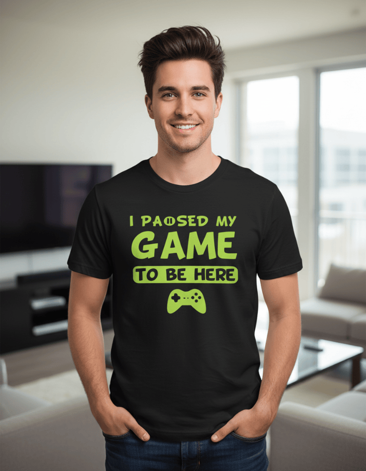 Model wearing "I Paused My Game to be Here" UV-Reactive Neon T-Shirt by Neon DripWear, showcasing vibrant colors and design.