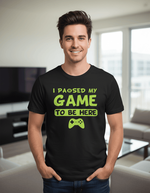 Model wearing "I Paused My Game to be Here" UV-Reactive Neon T-Shirt by Neon DripWear, showcasing vibrant colors and design.